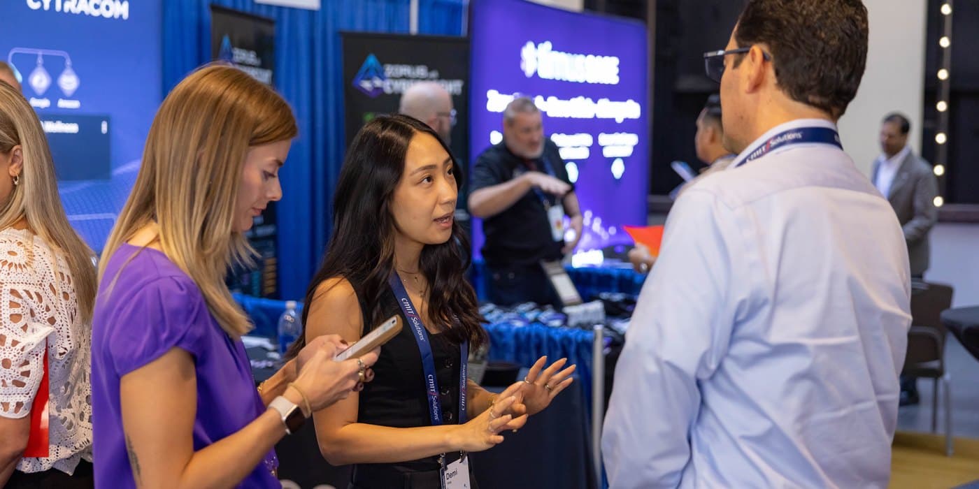 Jorge talking with a vendor at the CMIT Solutions expo