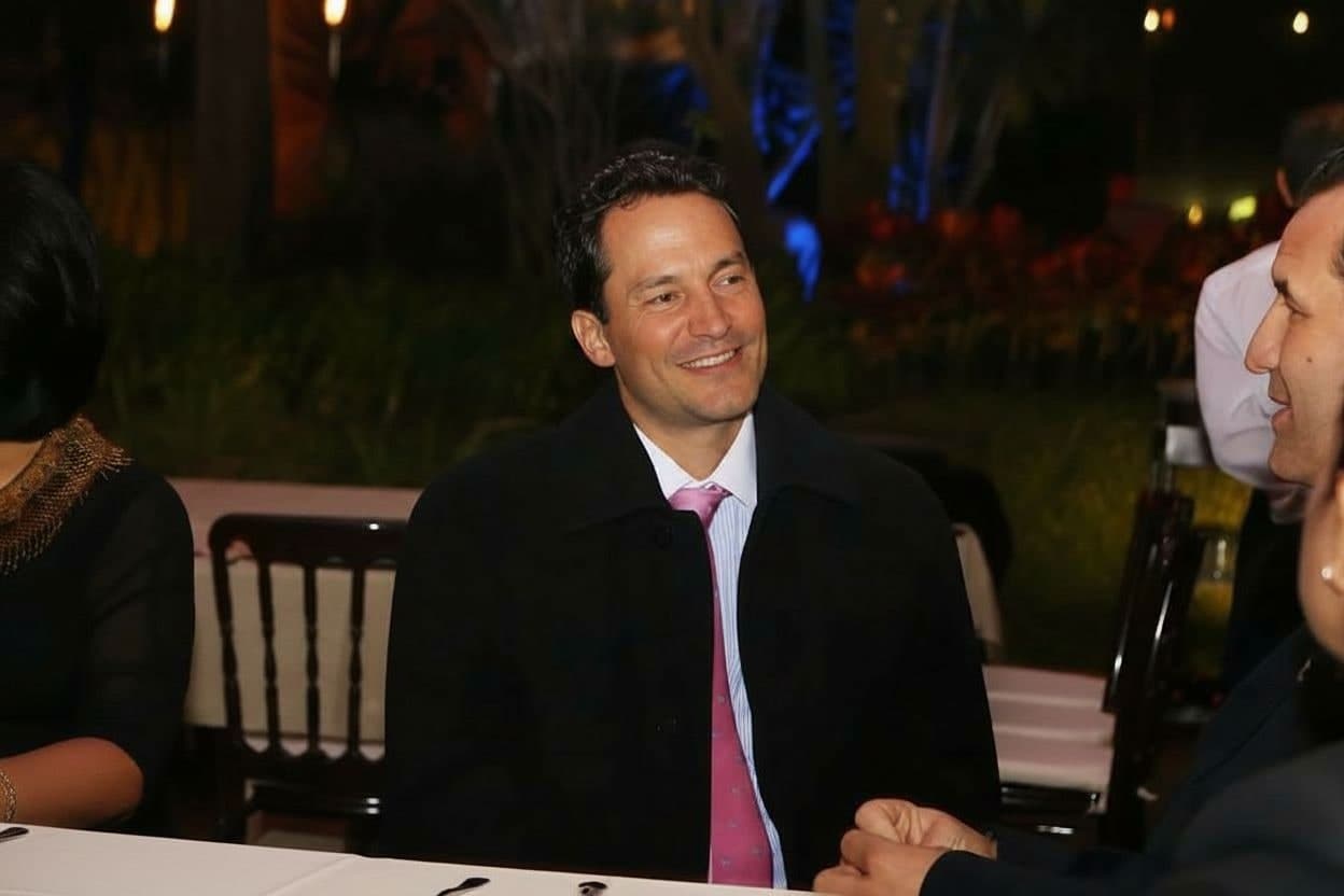 Jorge Velasquez listening to a client over dinner