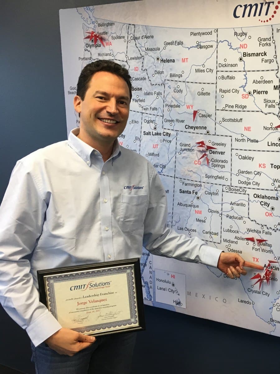 Jorge Velasquez pointing at Austin on the CMIT Solutions territory map